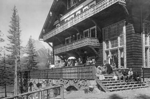 Many Glacier Hotel with guests on porch